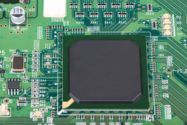 A microprocessor soldered into a green motherboard. — Stock Photo, Image