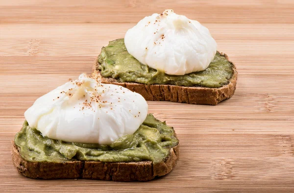 Sandwiches with poached eggs and avocado paste on cereal bread. Healthy eating, healthy lifestyle.