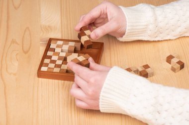 Hafif kazaklı kız bir polimino yapbozu birleştirmeye çalışıyor..