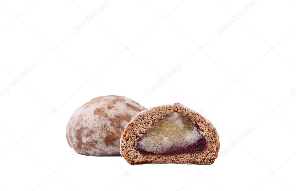 Glazed gingerbread with honey-fruit filling isolated on a white background. Gingerbread in a cut with fruit jam and honey. Copy space.