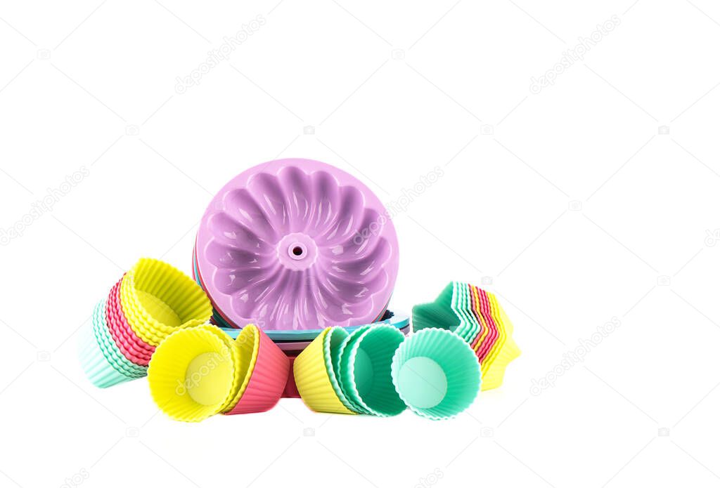 Multi-colored silicone cake baking dishes isolated on a white background. Copy space.