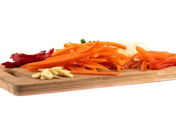 Sliced onions, garlic, carrots, sweet peppers on a cutting board. — Stock Photo, Image