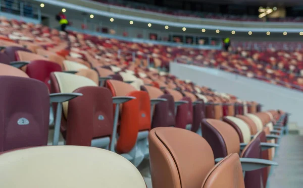 Multi-colored armchairs in a sports stadium