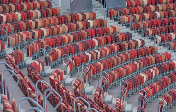 Multi-colored armchairs in a sports stadium