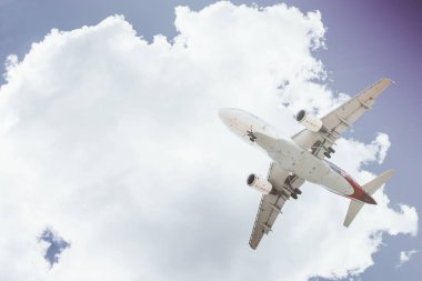 Arka plan mavi gökyüzü ve beyaz bulutlar uçakta.