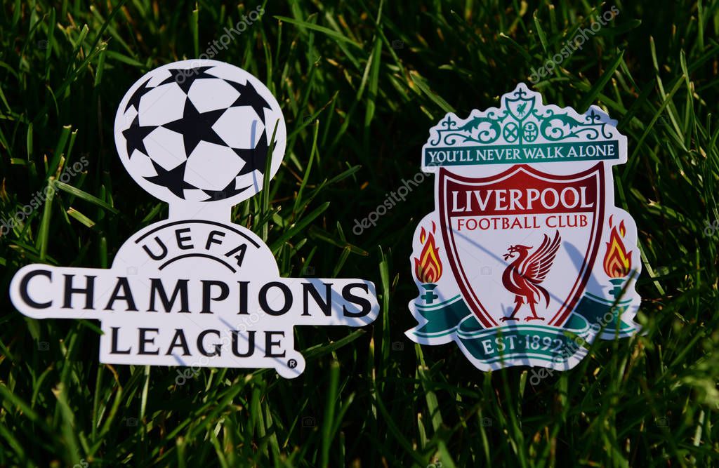 September 6, 2019 Istanbul, Turkey. The emblem of the English football club Liverpool next to the logo of the Champions League on the green grass of the football field.