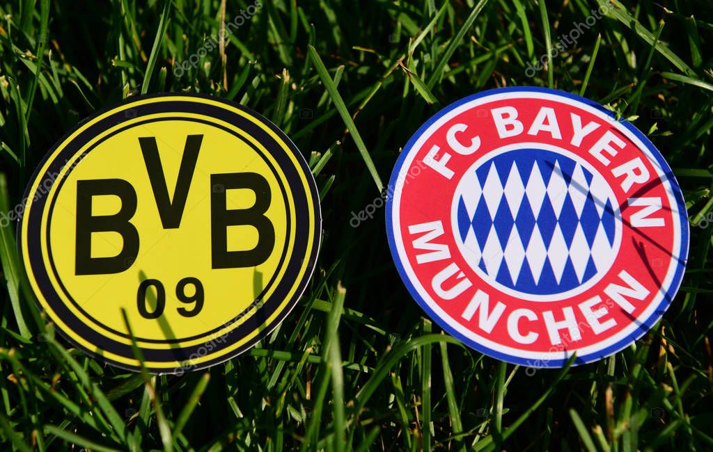 September 6, 2019, Munich, Germany. Emblems of German football clubs Bayern Munich and Borussia Dortmund on the green lawn