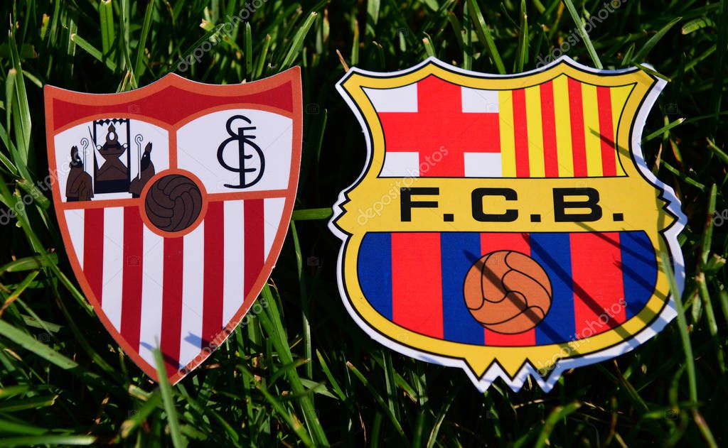 September 6, 2019, Madrid, Spain. Emblems of Spanish football clubs Barcelona and Sevilla on the green grass of the lawn.