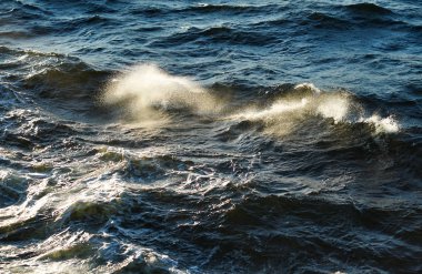 Small waves in the sea at sunset