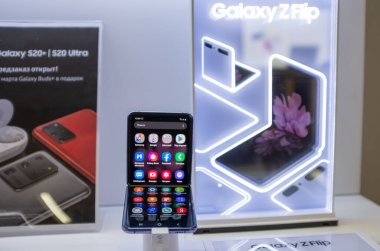 February 22, 2020, Moscow, Russia. New folding smartphone with a folding screen Samsung Galaxy Z Flip on the store counter. clipart