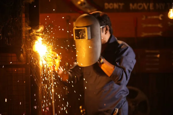 Man welding in shed