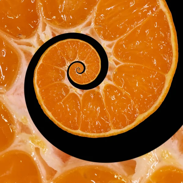 Isolated on black orange slice spiral swirl abstract fractal background. Orange slice spiral background pattern. Impossible abstract orange food fractal background. Surreal orange mandarin fruit swirl abstract fractal