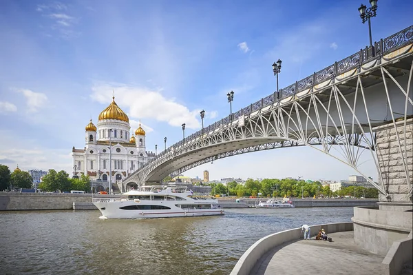 Summer sunny day view on the Cathedral of Christ the Savior church cathedral, touristic passenger ship boat on river, metal bridge. Moscow church temple. Moscow temple. River boat tour ship travel