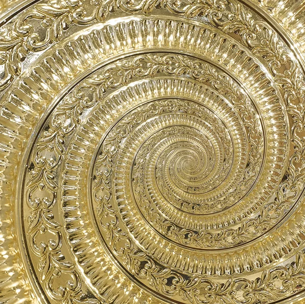 Golden metal abstract spiral background pattern fractal. Decorative ornament element. Golden metallic decorative ornament element. Gold metallic background pattern. Vintage golden metal background
