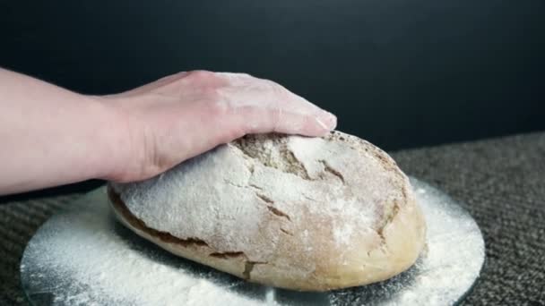 妇女的手抚摸面包 这是洒面粉 在黑色的背景 — 图库视频影像