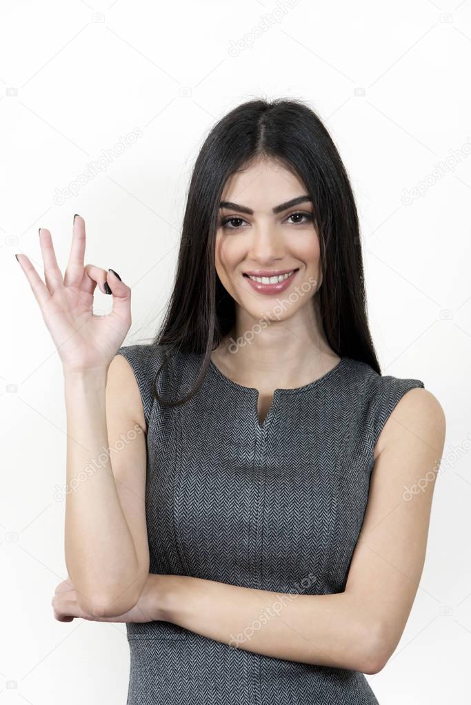Young business woman giving ok hand sign