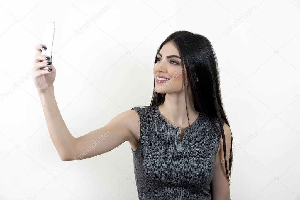 Business woman taking selfie with her smartphone.