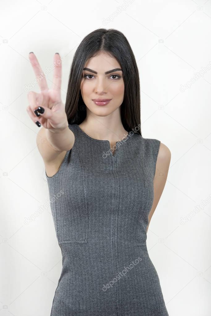 Business woman doing the peace sign.