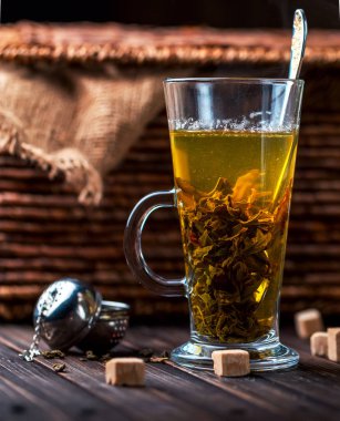 Ahşap zemin üzerine saydam bir kupa sıcak çay