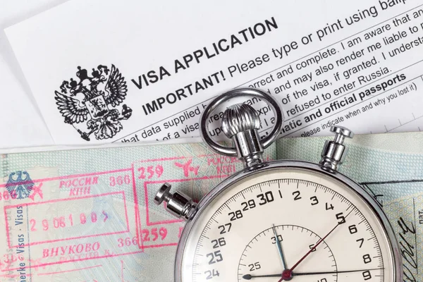 Visa application for russia with passpotr and stopwatch