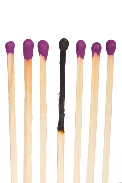 Burned matches over white background