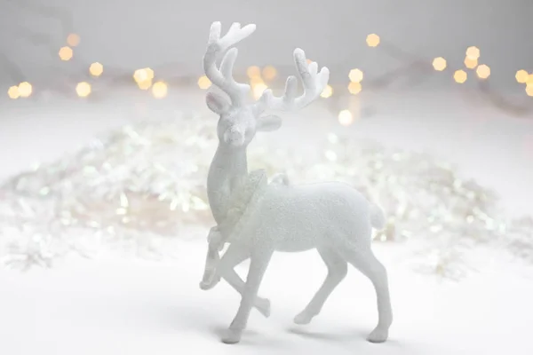 White Christmas decoration in scandinavian style with reindeer and bokeh lights