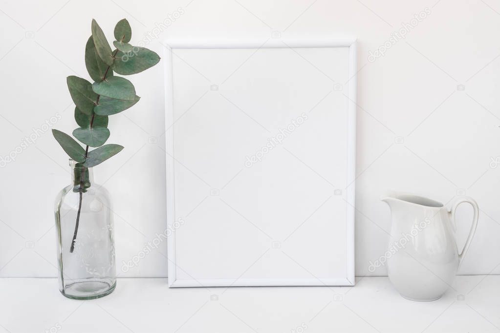 White frame mockup, eucalyptus branch in glass bottle, pitcher, styled minimalist clean image for product marketing
