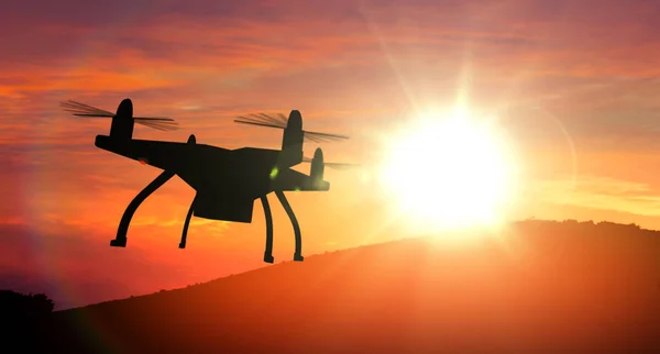 Drone silhouette flying towards sun.