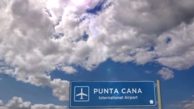 Punta Cana, Dominik Cumhuriyeti 'ne Jet uçağı iniyor. Havaalanı istikameti işaretli şehir gelişi. Seyahat, iş, turizm ve ulaşım konsepti. 3B canlandırma canlandırması.