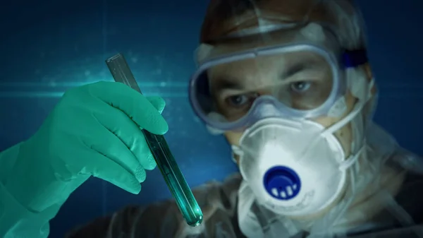 Scientist in mask and protection glass with test-tube in glove hand. Concept of laboratory, science research, biology, chemistry experiment, biotechnology, health, medical, virus search and pharmacy.