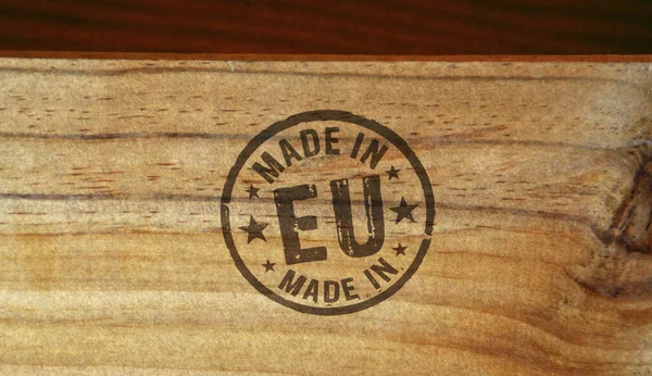 Made in EU, Europe, European Union stamp printed on wooden box. Factory, manufacturing and production country concept.