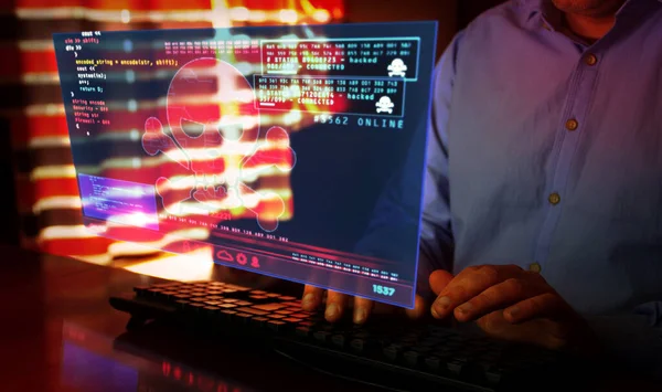 Hacker typing on the keyboard and breaks computer security on virtual hologram screen on desk. Cyber attack, cybercrime, piracy, digital safety and identity theft concept.
