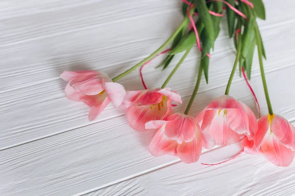 Houten witte achtergrond en roze tulpen. 8 maart, Mother's Day. — Stockfoto