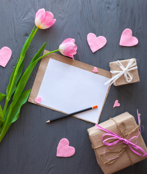 Wooden white background,letter and tulips. March 8, Mother's Day.