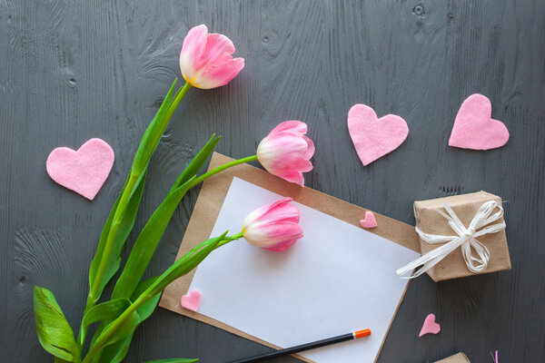 Wooden white background,letter and tulips. March 8, Mother's Day.