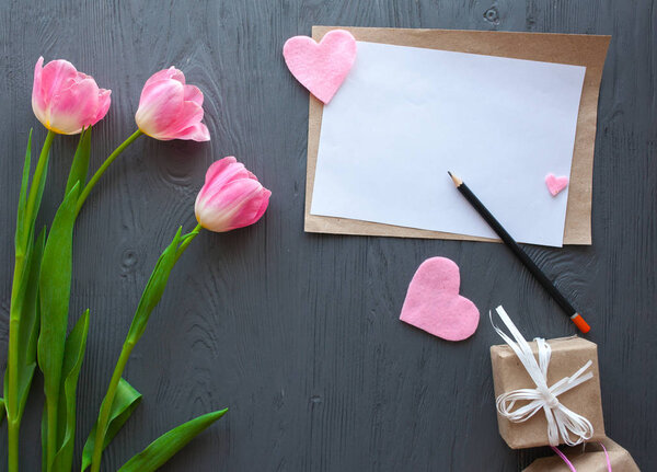 Wooden white background,letter and tulips. March 8, Mother's Day.