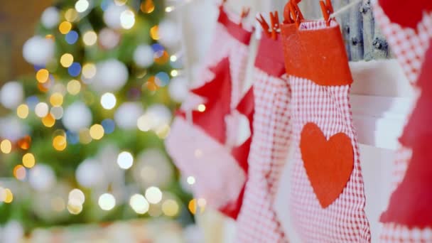 Close up of Christmas stockings hanging on fireplace in cozy living room — Stock Video