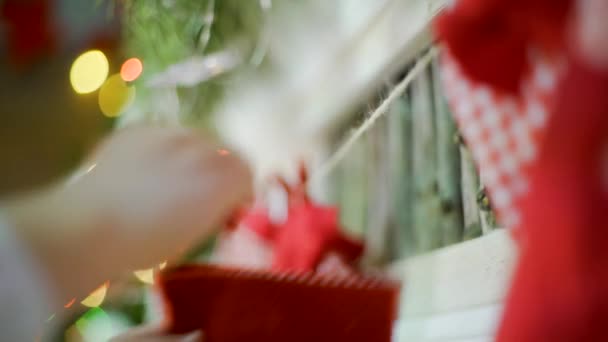 Close up of Christmas stockings hanging on fireplace in cozy living room — Stock Video