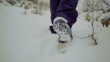 ağır çekim. Whit backpackfoot ayak yükseltiler kar kış manzara içinde yakın çekim erkekler yürümek