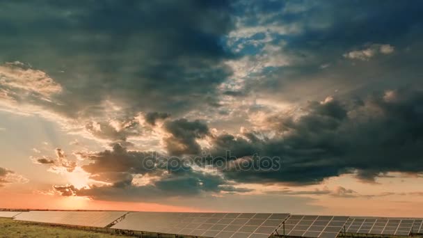 Time Lapse, Rich yellow, orange, red colors light up solar panel at sunset. move cloud — Stock Video