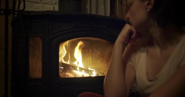 SLOW MOTION, Woman looks at Fireplace. Relaxed holiday evening concept. Close up — Stock Video