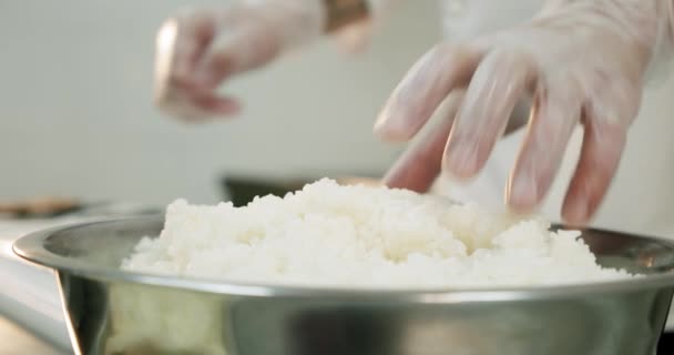 Restaurantküche männlicher Sushi-Koch bereitet japanische Sushi-Reisrollen zu. Nahaufnahme der Hände. — Stockvideo