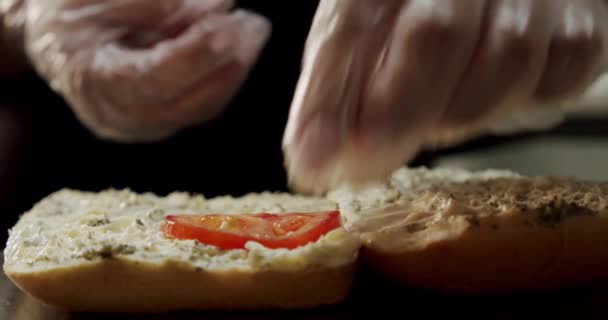 Põe o tomate no pão. Menina fazendo sanduíche com salame. Movimento lento — Vídeo de Stock