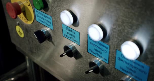 Man hand pushing buttons and the light begins to glow on industrial equipment for engineer controlling automated production line on control panel. Close up — Stock Video