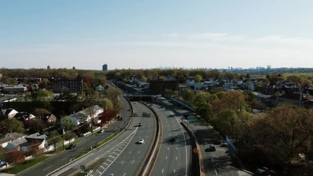 Widoki lotnicze lot oewr wielu pasa ruchu autostrady prowadzącej w kierunku Nowego Jorku panoramy na horyzoncie domów sąsiedzkich na przedmieściach Yonkers, z widokiem na Nowy Jork — Wideo stockowe