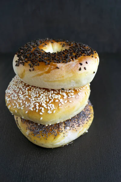 Bagels with sesame seeds on a black background — Stock Photo, Image