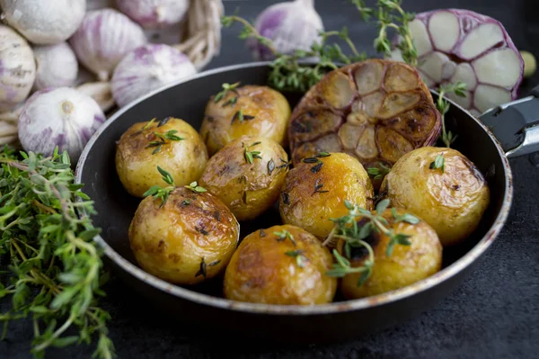 Fried potatoes in a pan with garlic and thyme. — Stock Photo, Image