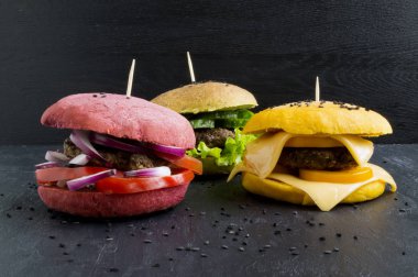 Hamburgers with colored buns. clipart