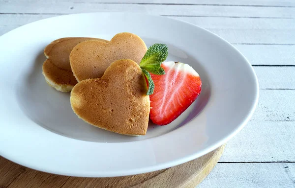 Pancakes in the shape of a heart with berries. — Stock Photo, Image