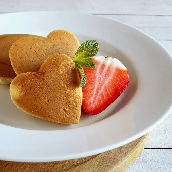 Pancakes in the shape of a heart with berries. — Stock Photo, Image